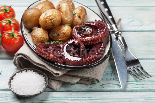 Grilled octopus with small potatoes Stock photo © karandaev