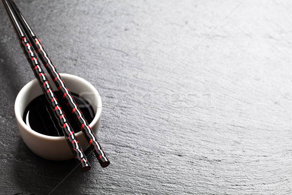 Japanese sushi chopsticks over soy sauce bowl Stock photo © karandaev