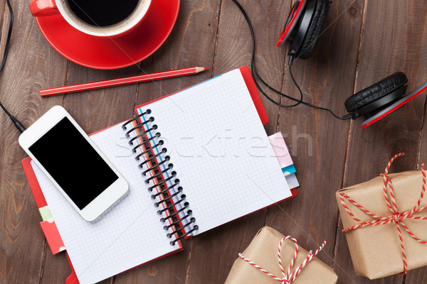 Desk with notepad, smartphone and gift boxes Stock photo © karandaev