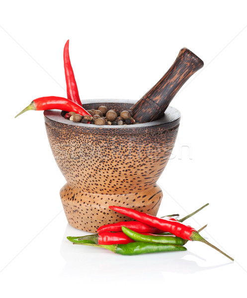 Mortar and pestle with red hot chili pepper and peppercorn Stock photo © karandaev