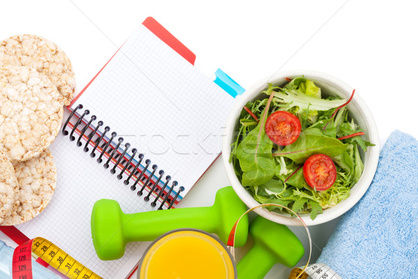 Dumbells, tape measure, healthy food and notepad for copy space. Stock photo © karandaev