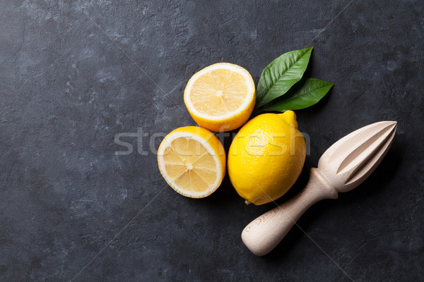 Lemons and juicer Stock photo © karandaev