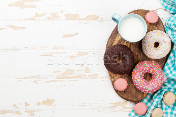 Milk and donuts on wooden table Stock photo © karandaev