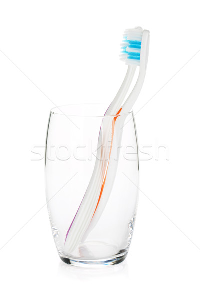 Two toothbrushes in a glass Stock photo © karandaev