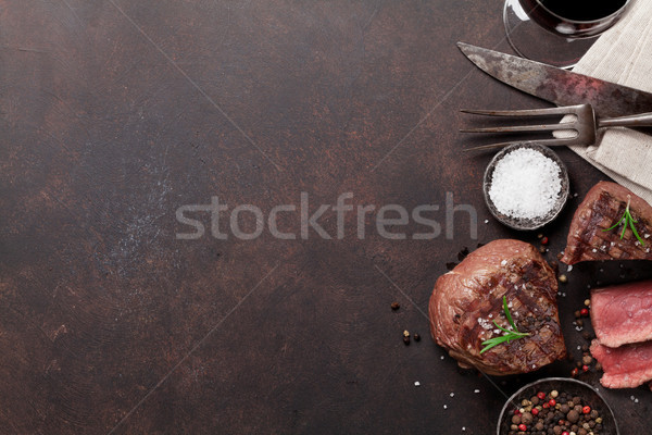 Grilled fillet steaks and glass of red wine Stock photo © karandaev