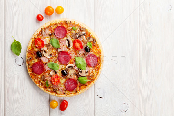 Italian pizza with pepperoni, tomatoes, olives and basil Stock photo © karandaev