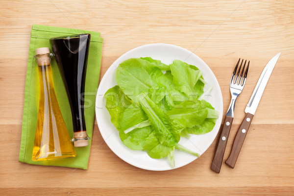 Plate with fresh salad, condiments, knife and fork. Diet food Stock photo © karandaev