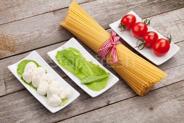 Stock photo: Tomatoes, mozzarella, pasta and green salad leaves