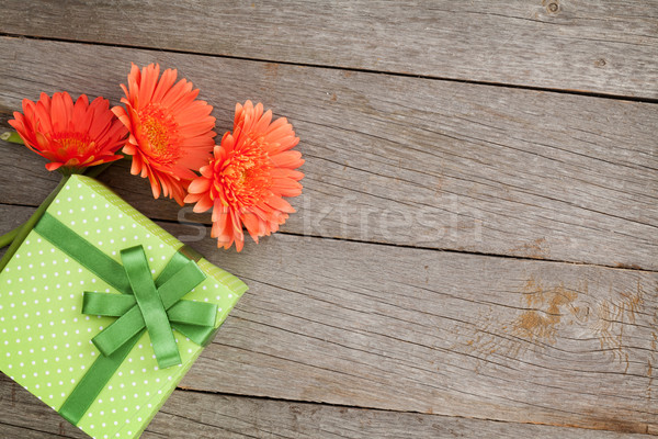 Orange gerbera flowers and gift box Stock photo © karandaev