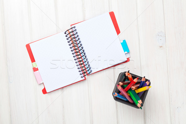 Whtie wooden table blank notepad and colorful pencils Stock photo © karandaev