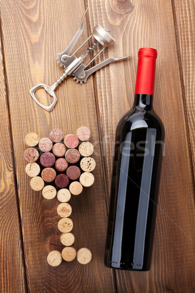 Red wine bottle, glass shaped corks and corkscrew. View from abo Stock photo © karandaev