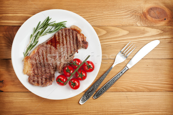 Sirloin steak with rosemary and cherry tomatoes on a plate Stock photo © karandaev