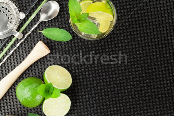 Mojito cocktail and ingredients over black rubber mat Stock photo © karandaev
