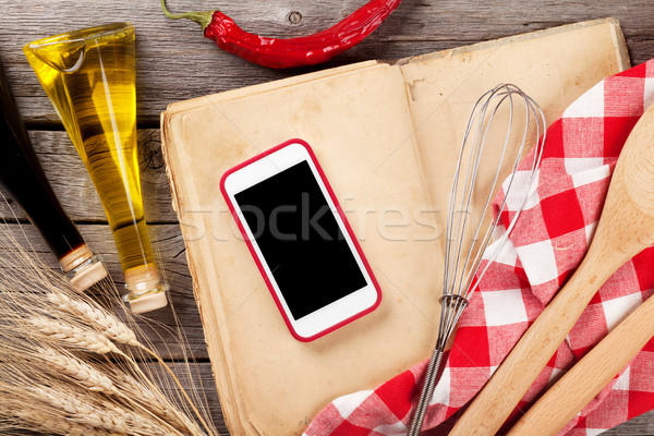 Kitchen table with ingredients, utensils and phone Stock photo © karandaev