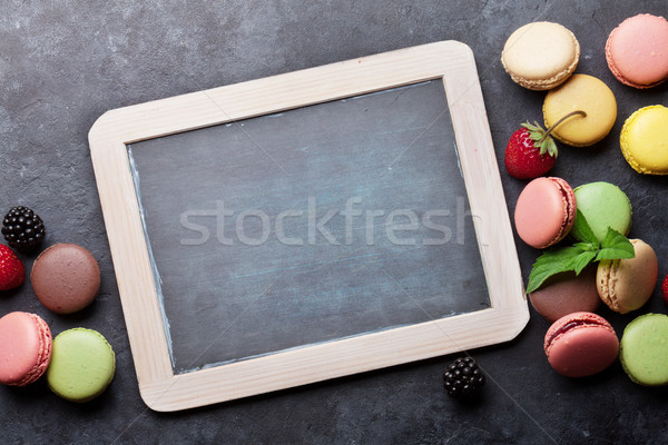 Colorful macaroons, berries and blackboard Stock photo © karandaev