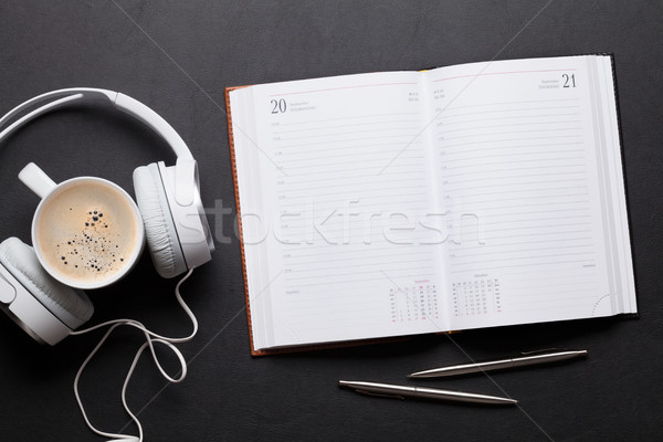 Office leather desk table with notepad, headphones and coffee Stock photo © karandaev