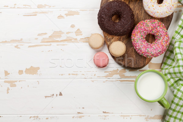 Milk and donuts on wooden table Stock photo © karandaev