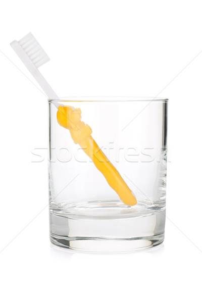 Baby toothbrush in a glass Stock photo © karandaev