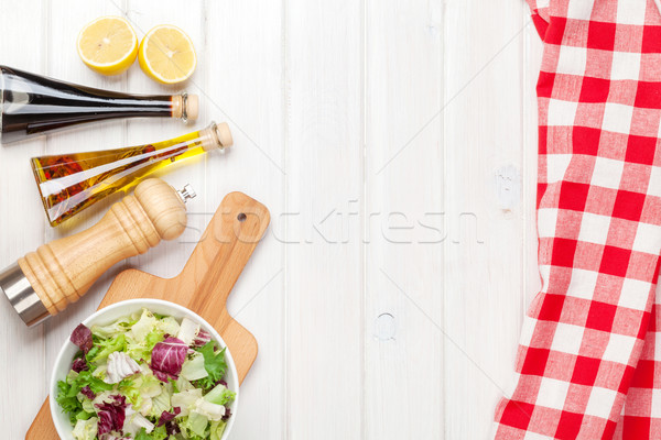 Fresh healthy salad and condiments over white wooden table Stock photo © karandaev
