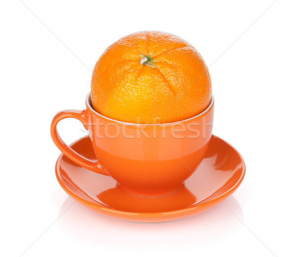 Ripe orange in tea cup Stock photo © karandaev