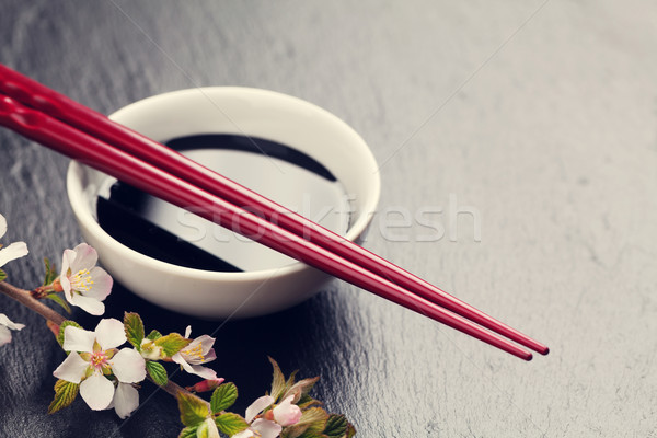 Japonés sushi palillos salsa de soja tazón sakura Foto stock © karandaev