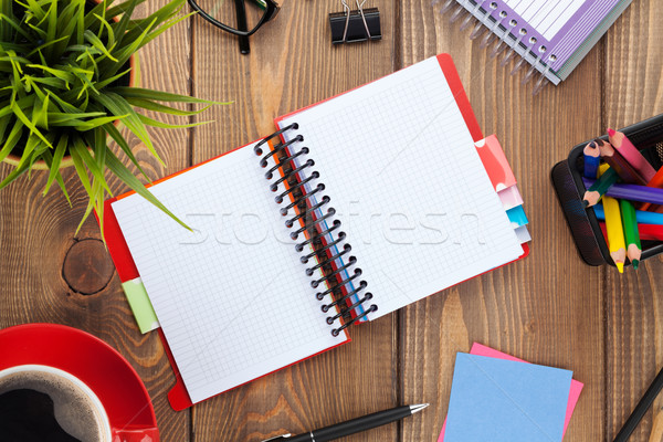 Office table with flower, blank notepad and coffee cup Stock photo © karandaev