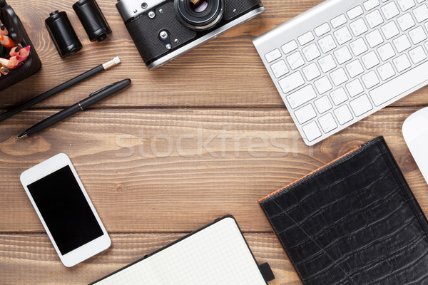 Office desk table with computer, supplies and camera Stock photo © karandaev