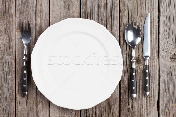 üres tányér ezüst étkészlet fa asztal felső kilátás Stock fotó © karandaev