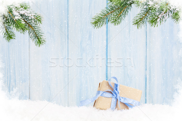 Christmas gift box and fir tree branch in snow Stock photo © karandaev