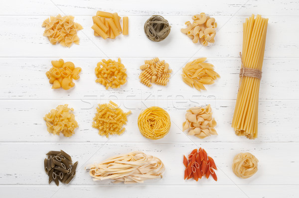 Various pasta on white wooden table Stock photo © karandaev