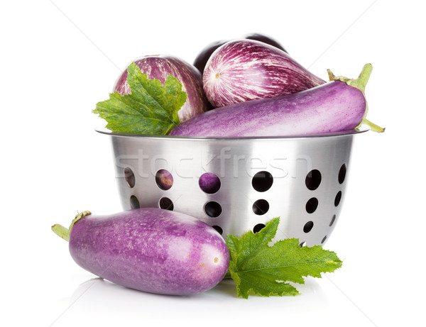 Fresh ripe eggplants in colander Stock photo © karandaev