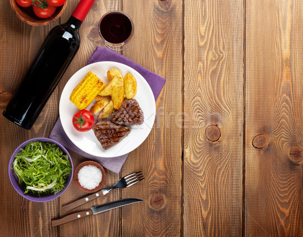 Stock photo: Steak with grilled potato, corn, salad and red wine