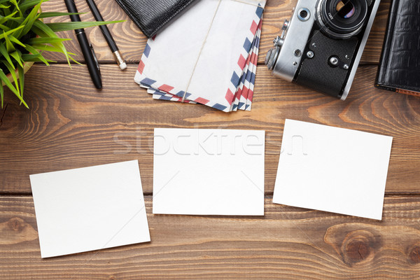 Blank photo frames, camera and supplies on table Stock photo © karandaev