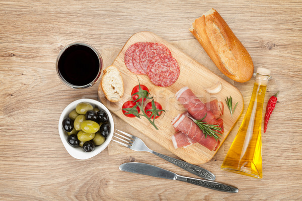 Red wine with cheese, olives, tomatoes, prosciutto, bread and sp Stock photo © karandaev