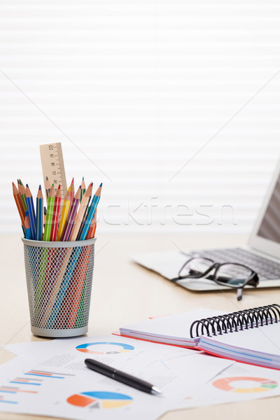 Office desk workplace with laptop, reports and pencils Stock photo © karandaev