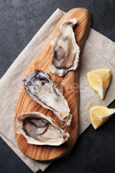 Stock photo: Oysters and lemon over ice