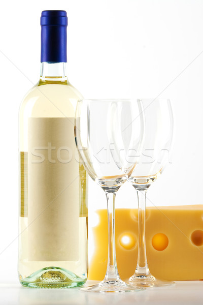 Stock photo: Bottle of white wine and two empty wine glasses and cheese