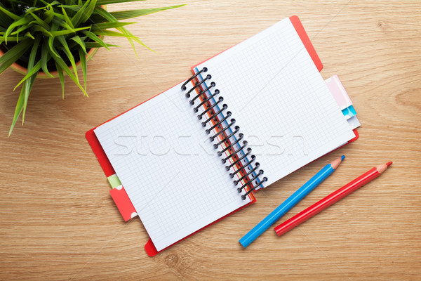 Stock photo: Office table with flower, blank notepad and colorful pencils