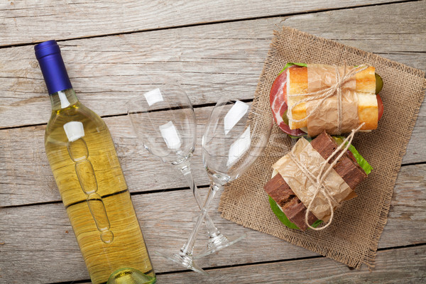 Iki sandviçler beyaz şarap ahşap masa üst görmek Stok fotoğraf © karandaev