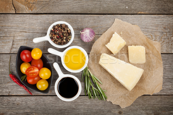 Parmezán sajt gyógynövények fűszer paradicsomok fa asztal papír Stock fotó © karandaev