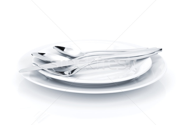 Silverware or flatware set over plates Stock photo © karandaev