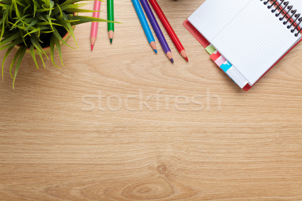 Office table with flower, blank notepad and colorful pencils Stock photo © karandaev