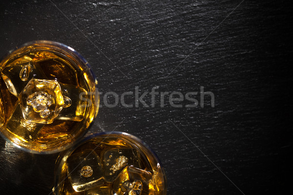 Szemüveg whiskey jég fekete kő asztal Stock fotó © karandaev