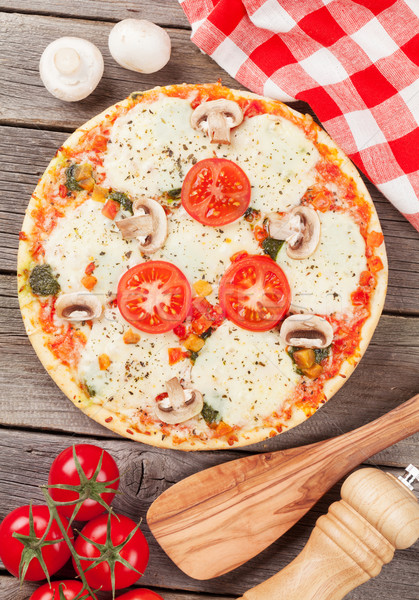 Pizza with tomatoes and mushrooms Stock photo © karandaev