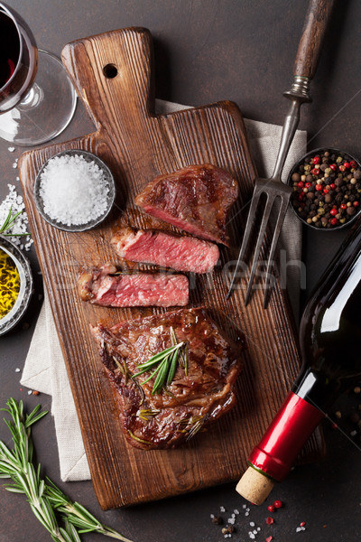 Grilled ribeye beef steak with red wine Stock photo © karandaev