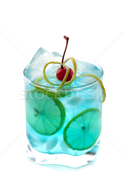 Blue alcohol cocktail with lemon slices and maraschino Stock photo © karandaev