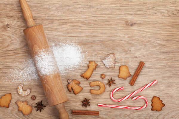 Stock photo: Rolling pin with flour, spices and cookies on wooden table