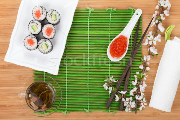 Red caviar, sushi set, sakura branch and green tea Stock photo © karandaev