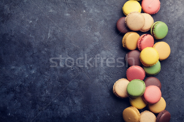 Colorful macaroons on stone table. Sweet macarons Stock photo © karandaev