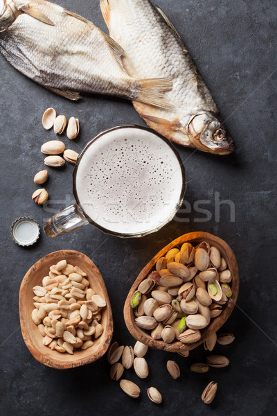 Világos sör sör harapnivalók kő asztal diók Stock fotó © karandaev